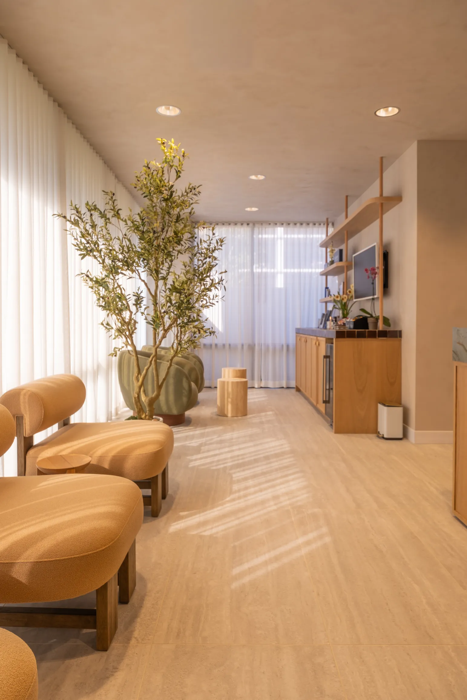 Close-up of the reception desk, pendant light, and decorative items on recessed wall shelves.